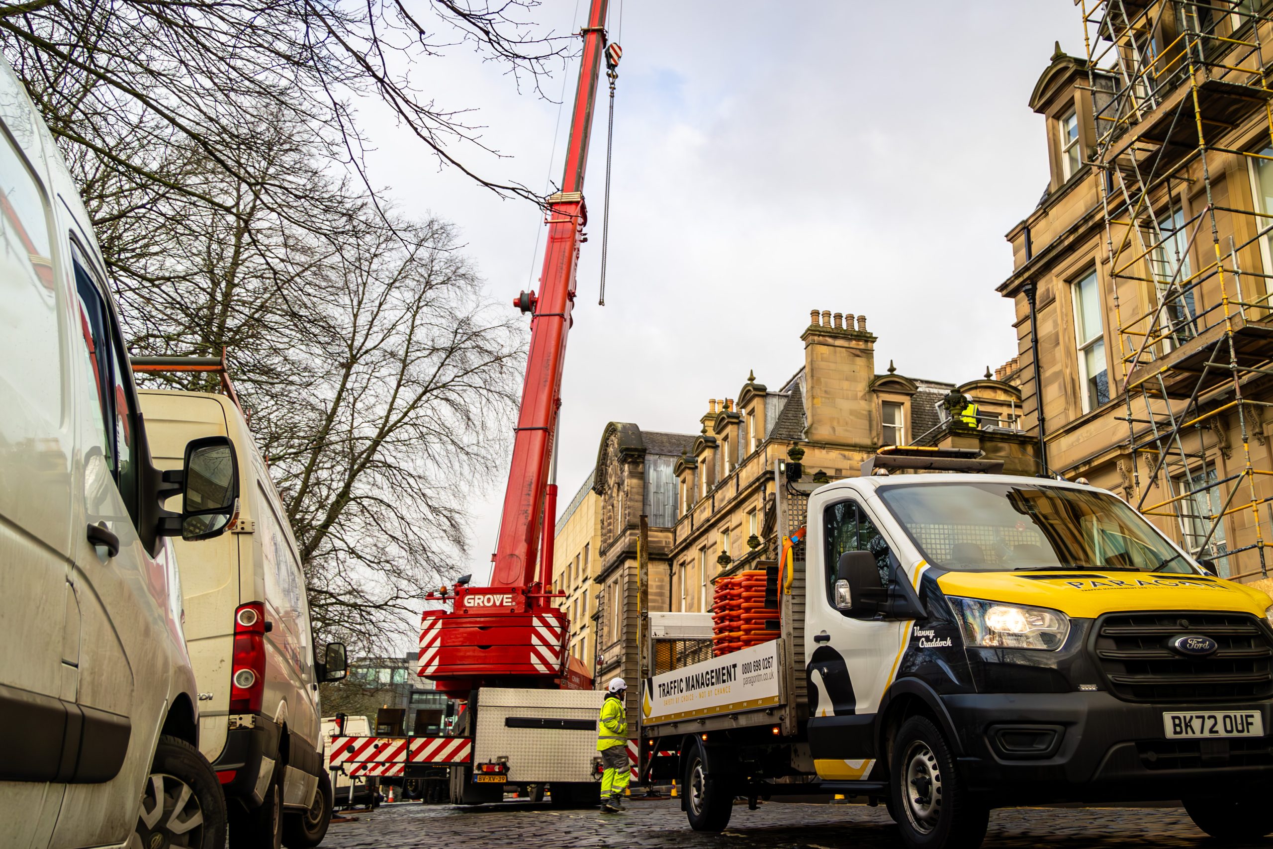 Paragon Traffic Management Van in Front of a Large Crane Working On Behalf of a Construction Company In Glasgow, Scotland